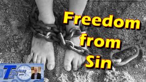 Black and white picture of feet chained with Yellow words Freedom from Sin overlay and logo in left corner